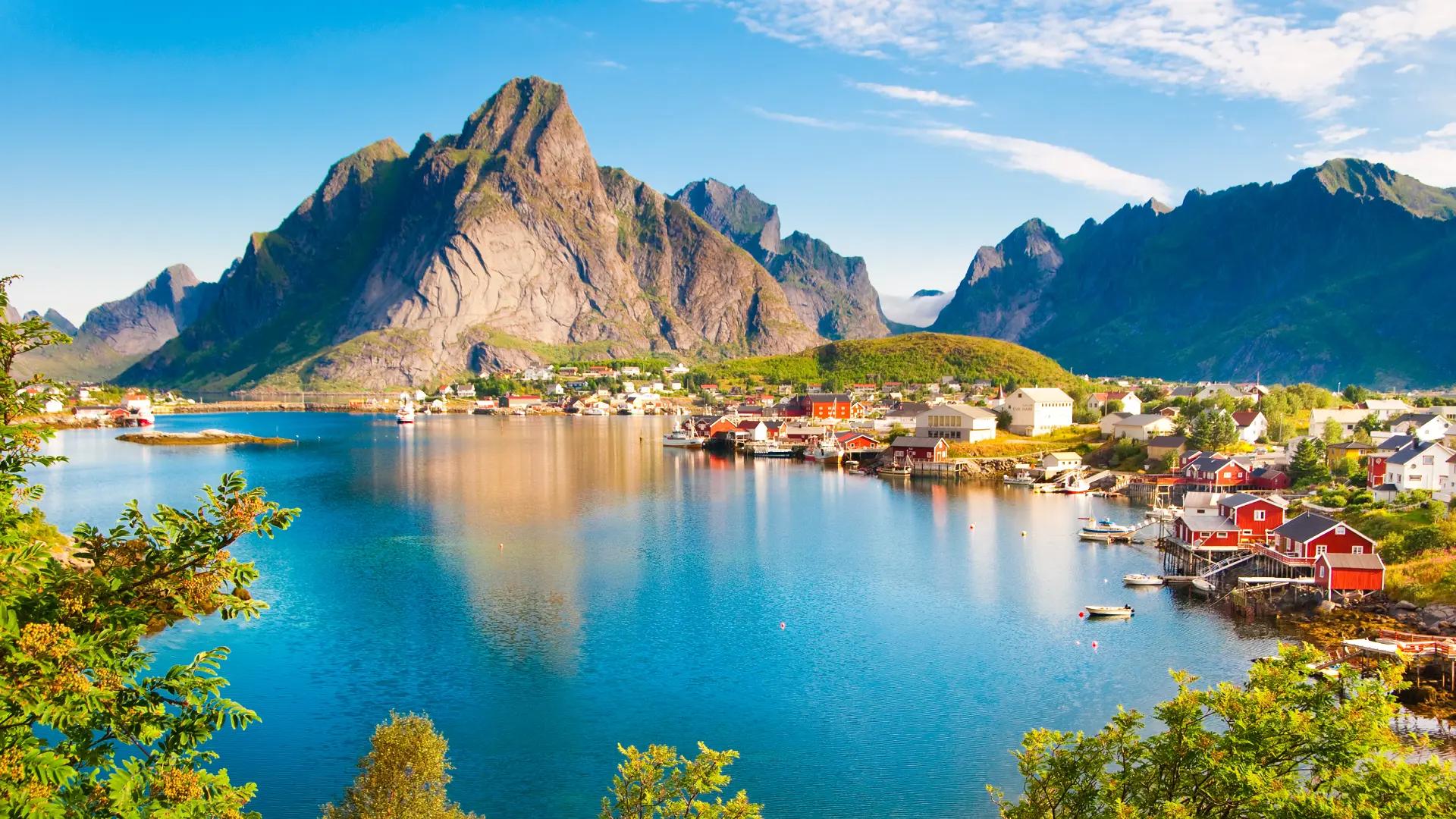Fishing village along the coastline in the Lofoten Islands, Norway, surrounded by mountains and fjords.