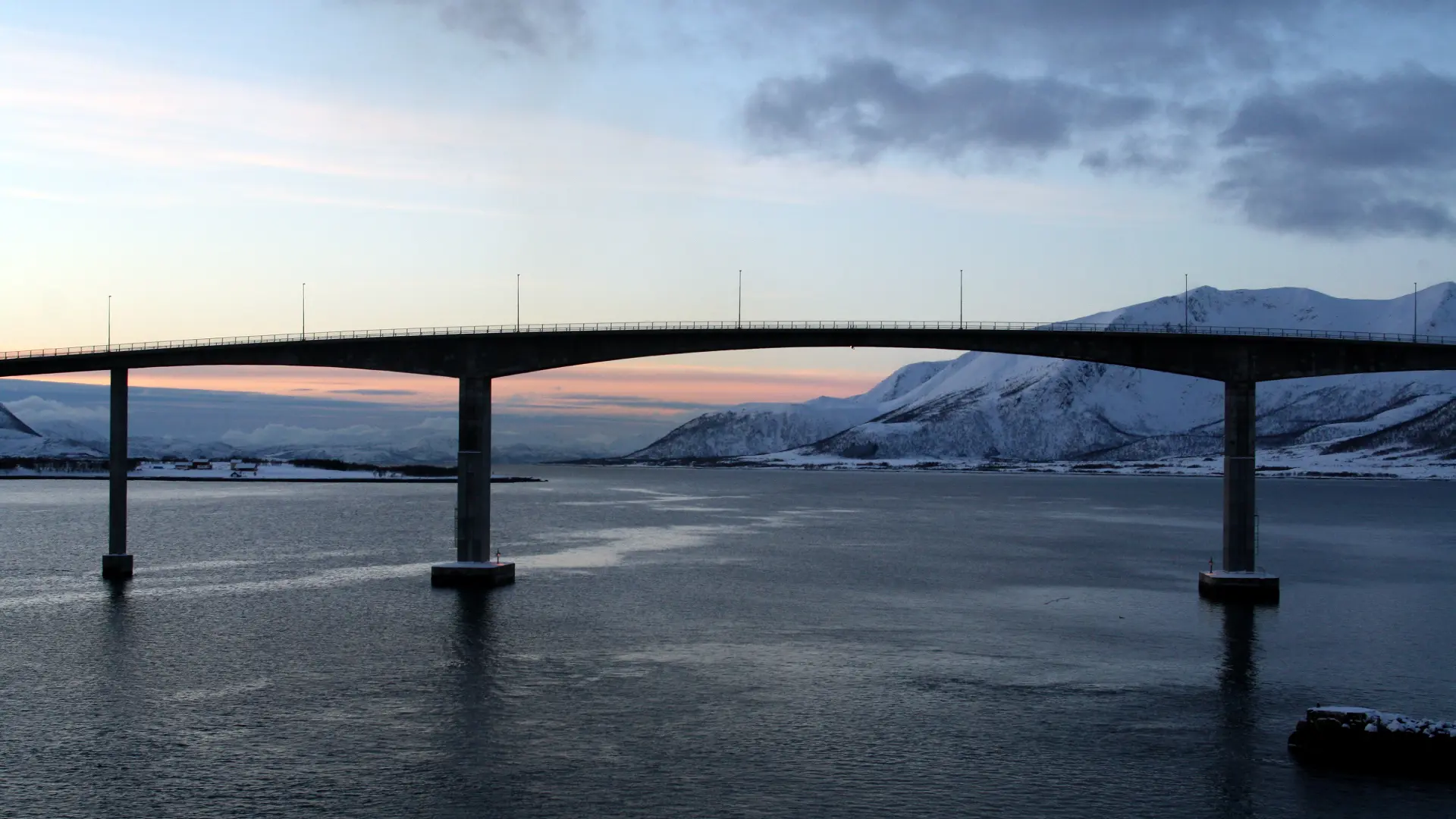 Bridge connecting islands across open water in the Lofoten Islands, Norway, during winter.