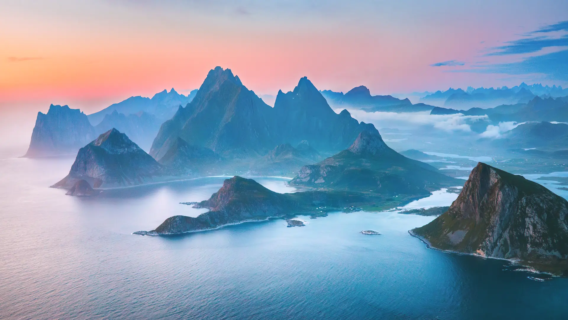 Aerial view of the Lofoten Islands archipelago with steep mountains and surrounding sea in northern
